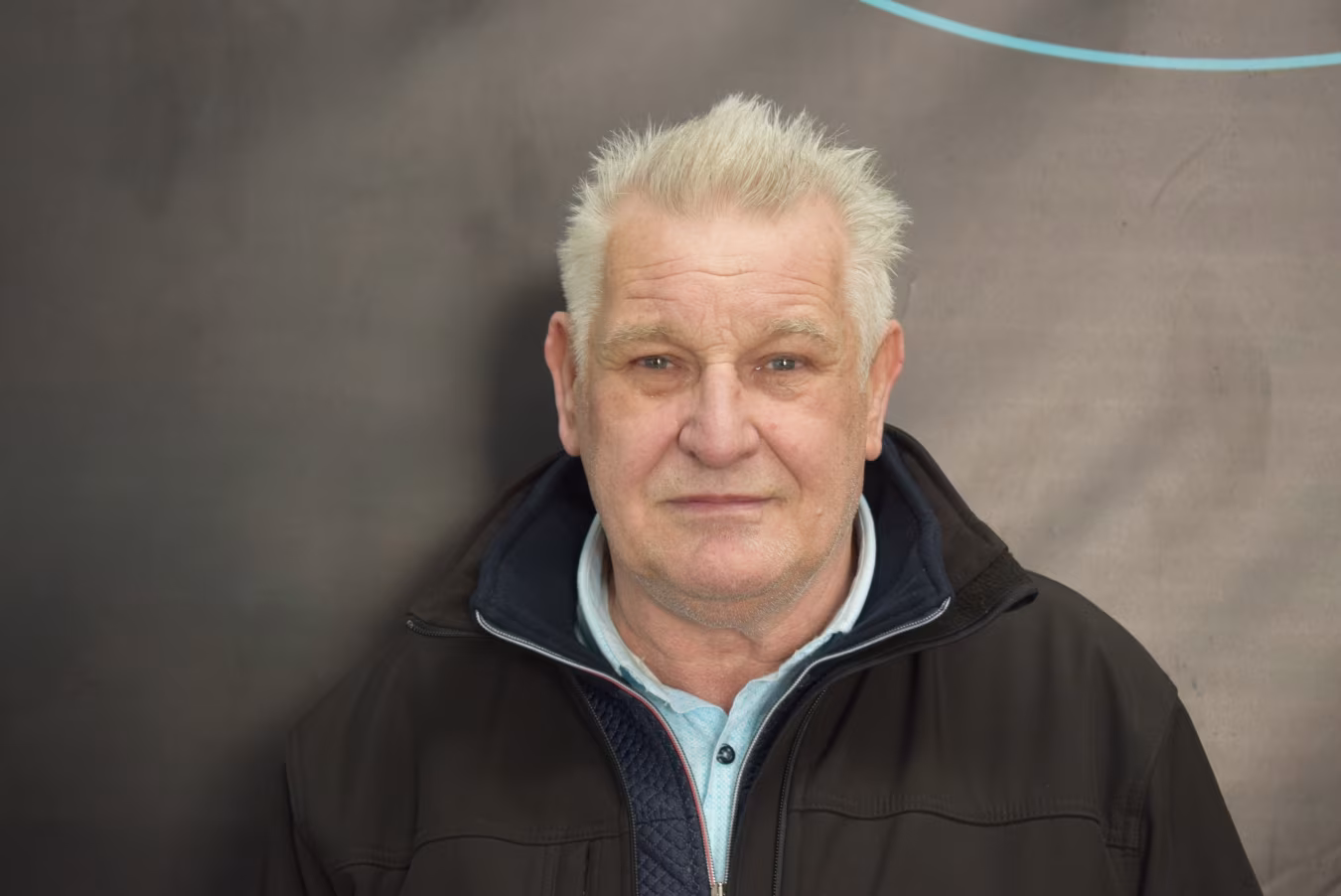 Winus Mulder portret bij Klein Autopoets Groningen, chauffeur en gastheer, formele en neutrale gezichtsuitdrukking