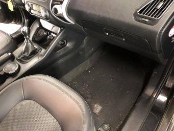 Interieur auto passagierskant focus vloer dashboard vloermat vuil handgeschakelde versnellingspook klein autopoets groningen